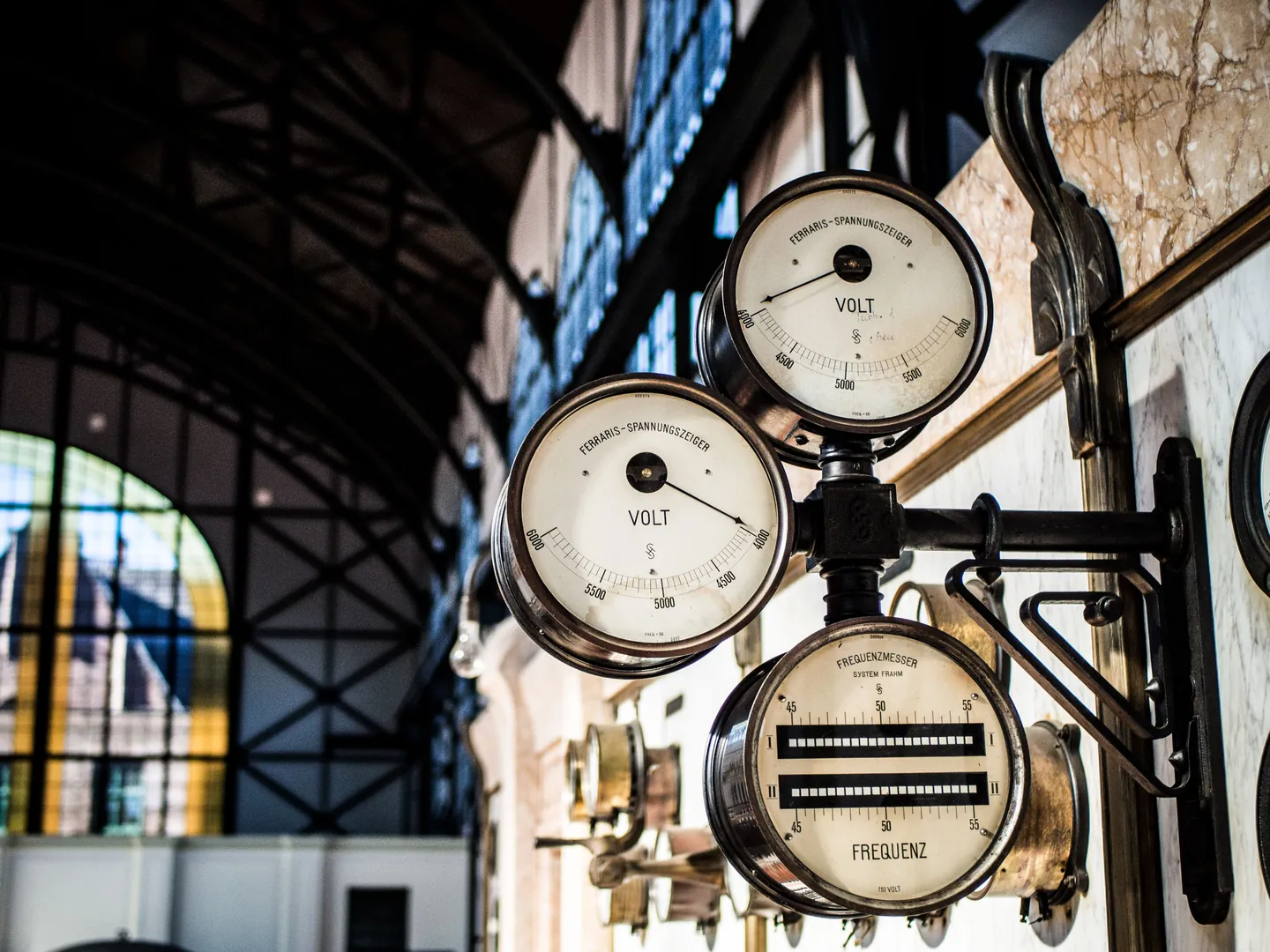 A bank of analogue pressure gauges on industrial pipework